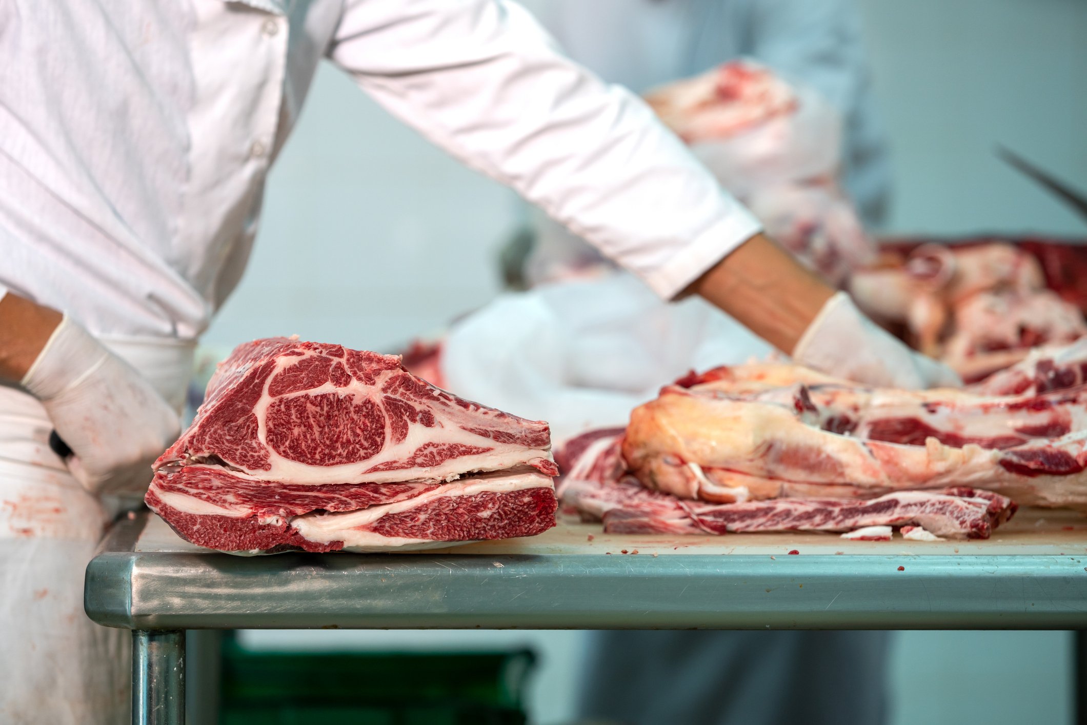 Butcher cutting meat